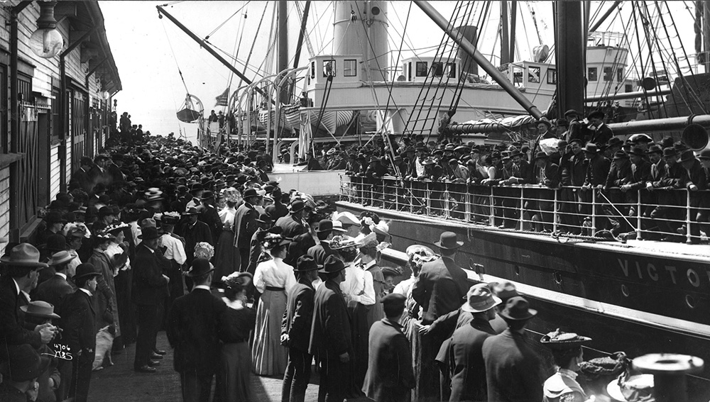 Seattle's bustling early waterfront with working vessels and maritime activity