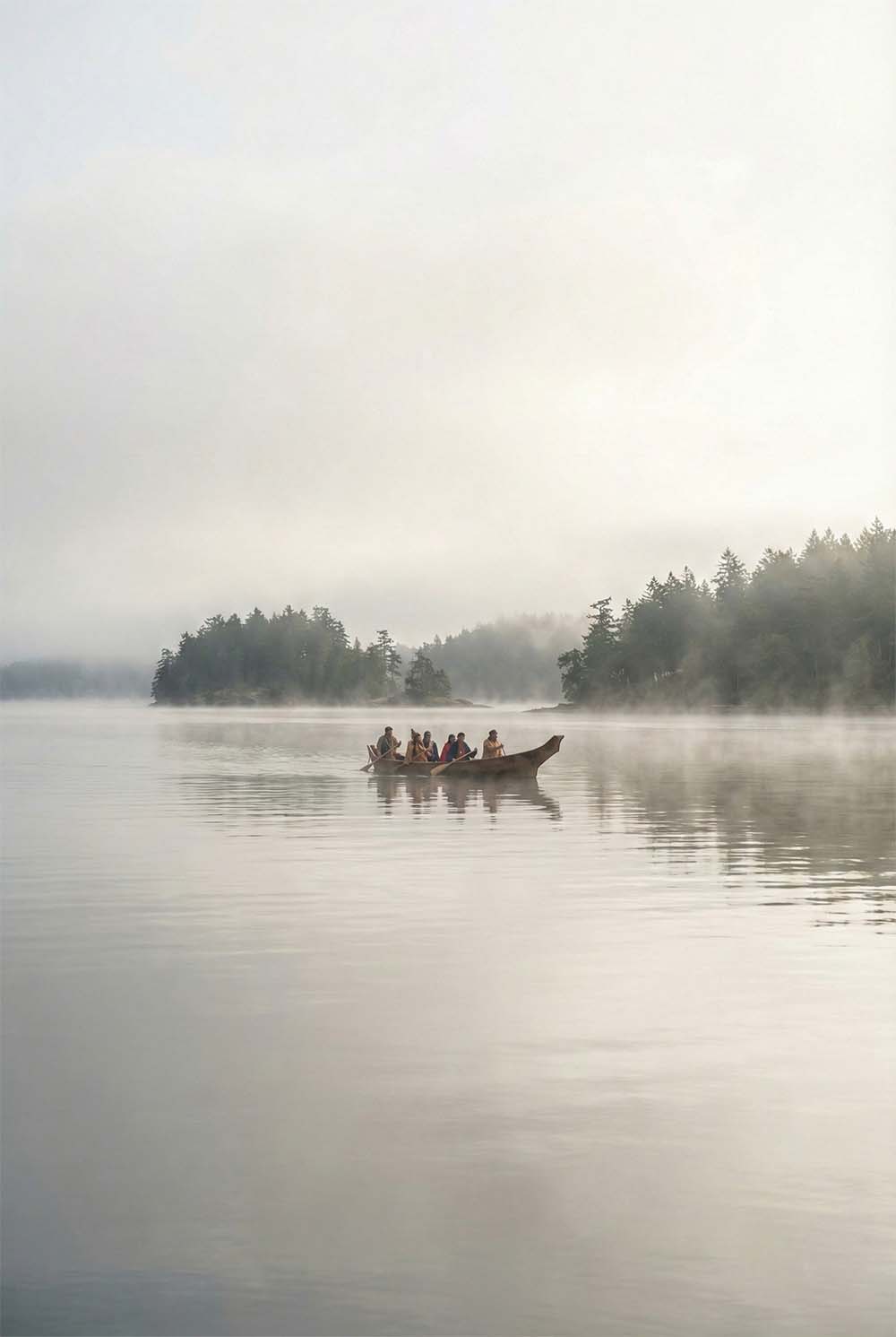 Coast Salish peoples navigating the undeveloped waters of Puget Sound by cedar canoe, with forested shoreline stretching into the distance