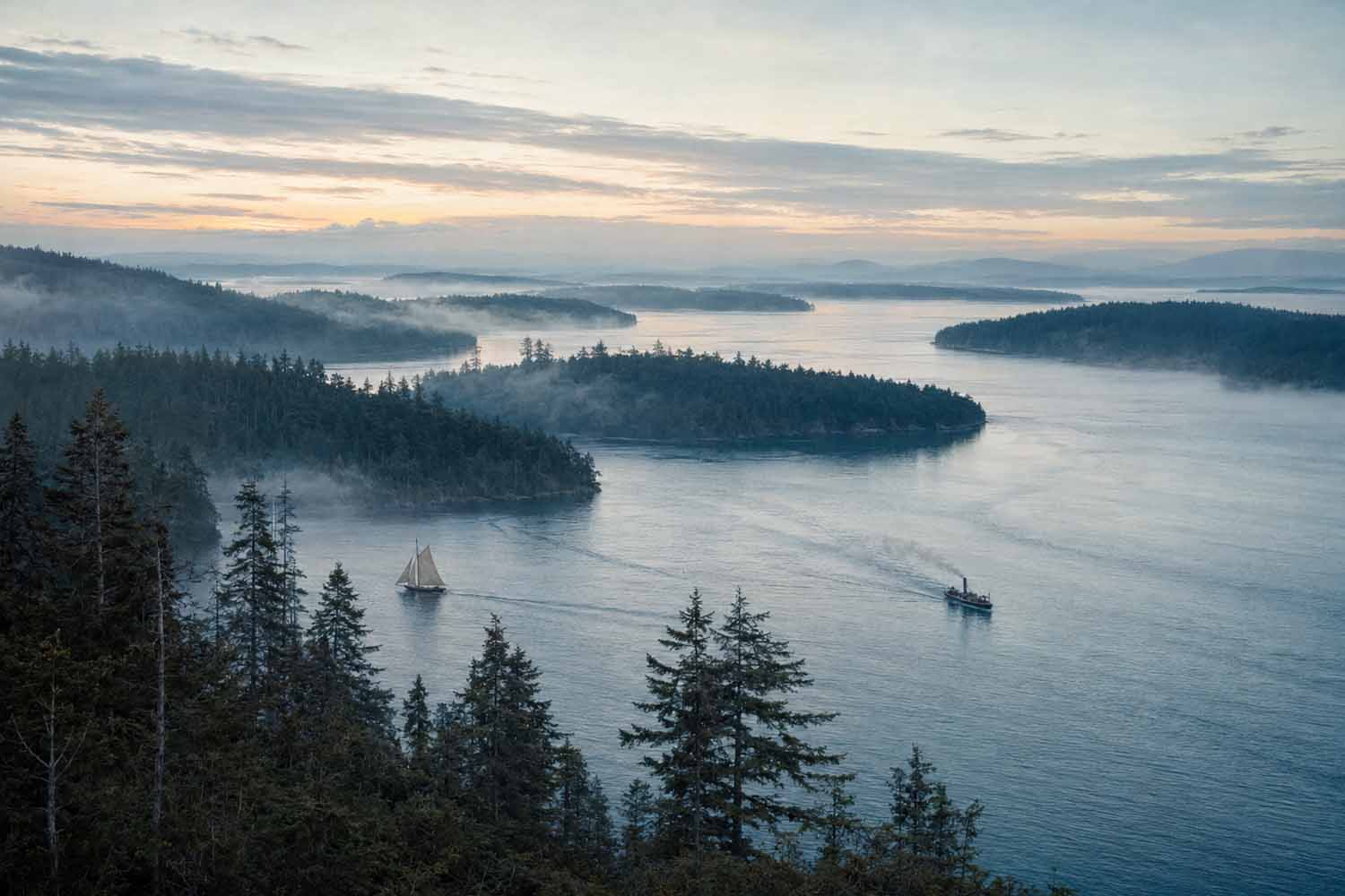 Seattle sailing history. Aerial view of Puget Sound's scattered islands and inlets, with small steamboats crossing the water in the early 1900s.